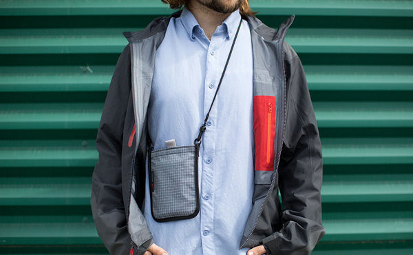 A person wearing the Passport Pouch around their neck.